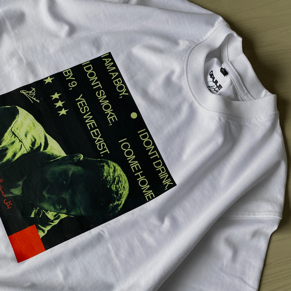 The GoodBoy Prithvi is a white oversized sweatshirt featuring a green-toned head graphic, stars, and yellow text: “I AM A BOY, I DON’T SMOKE, I DON’T DRINK, I COME HOME BY 9, YES WE EXIST.” Heavyweight 220 GSM; label: OVERT.